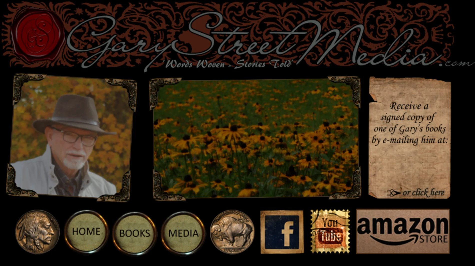 Website masthead on black: an ornate filigree banner with a red wax seal reading Gary Street Media dot com, Words Woven - Stories Told, beneath it a photograph of an older man in a fedora, a photograph of a field of black-eyed susans, and a torn kraft-paper panel; below, a nav row whose buttons are buffalo nickels alongside postage-stamp social icons and an Amazon Store button.